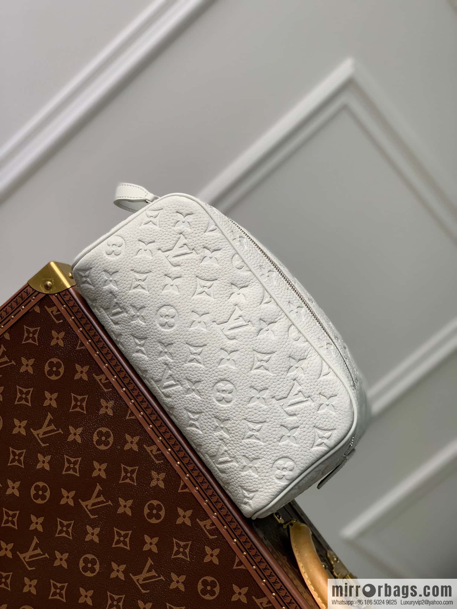 M82576 Gray and white, this Dopp Kit toilet bag.