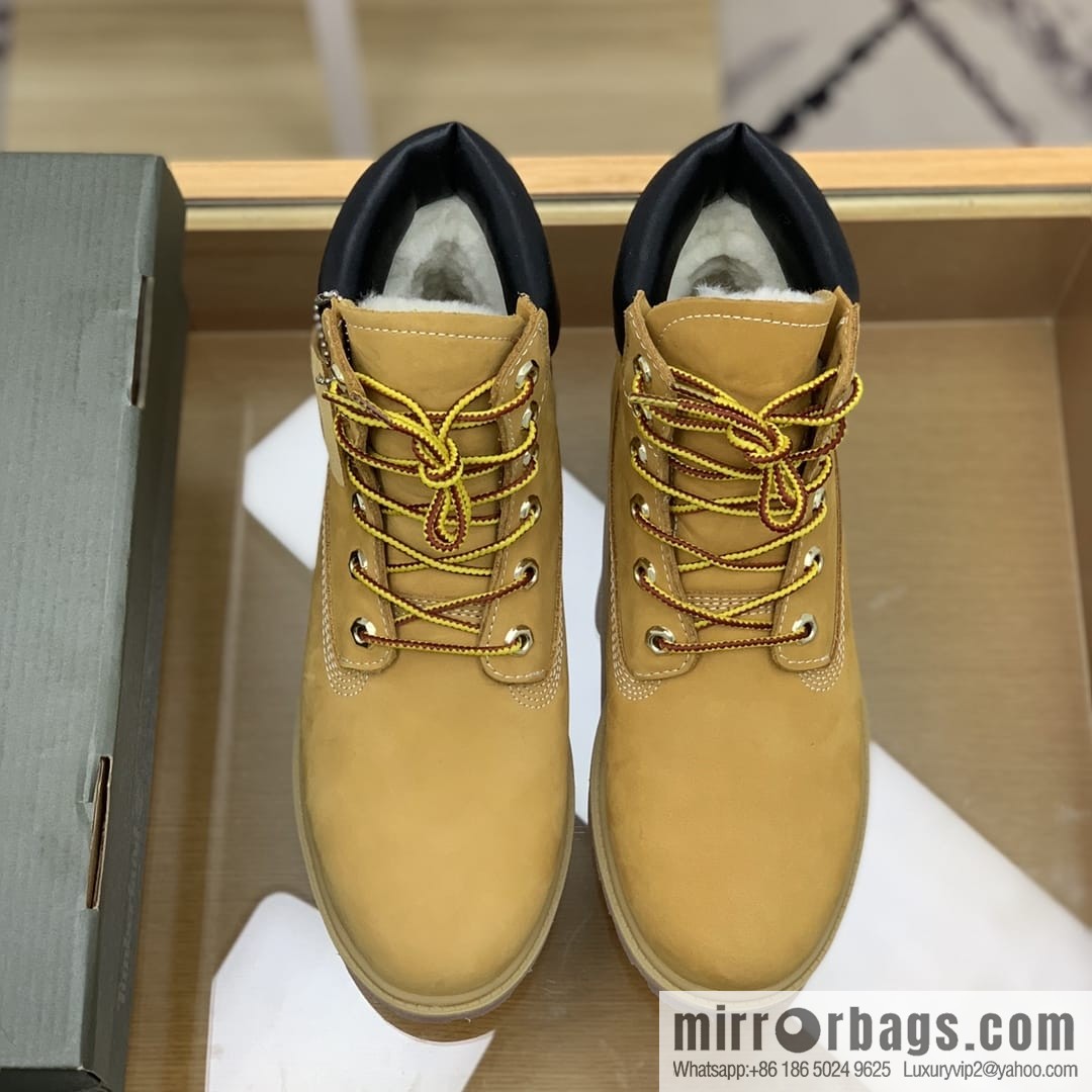 Timberland's beige frosted leather with white stitching and side stamping His & Hers boots