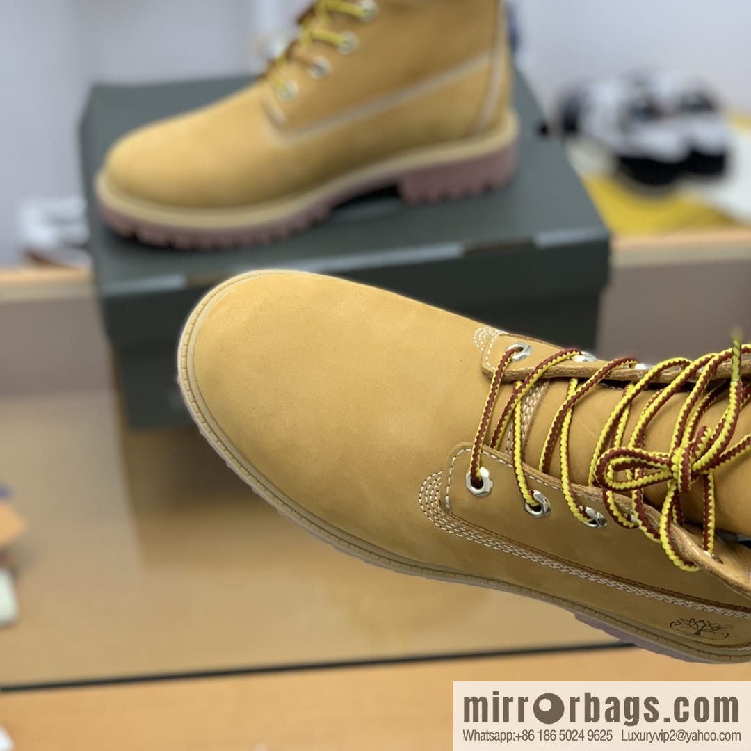 Timberland's beige frosted leather with white stitching and side stamping His & Hers boots