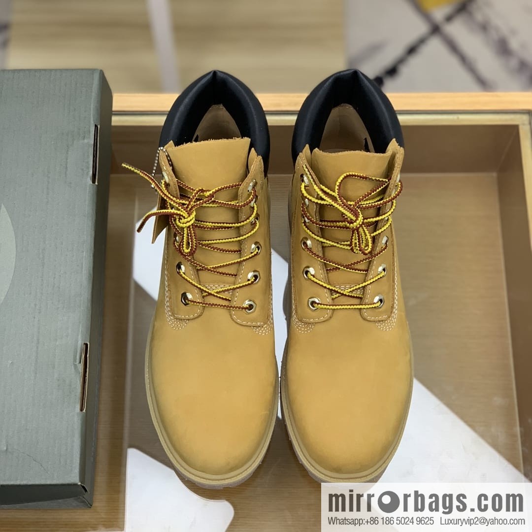 Timberland's beige frosted leather with white stitching and side stamping His & Hers boots