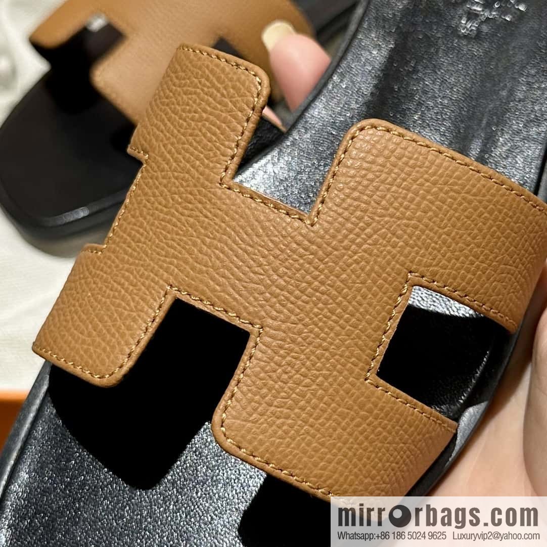 Hermès leather outsole H slippers, black and brown.