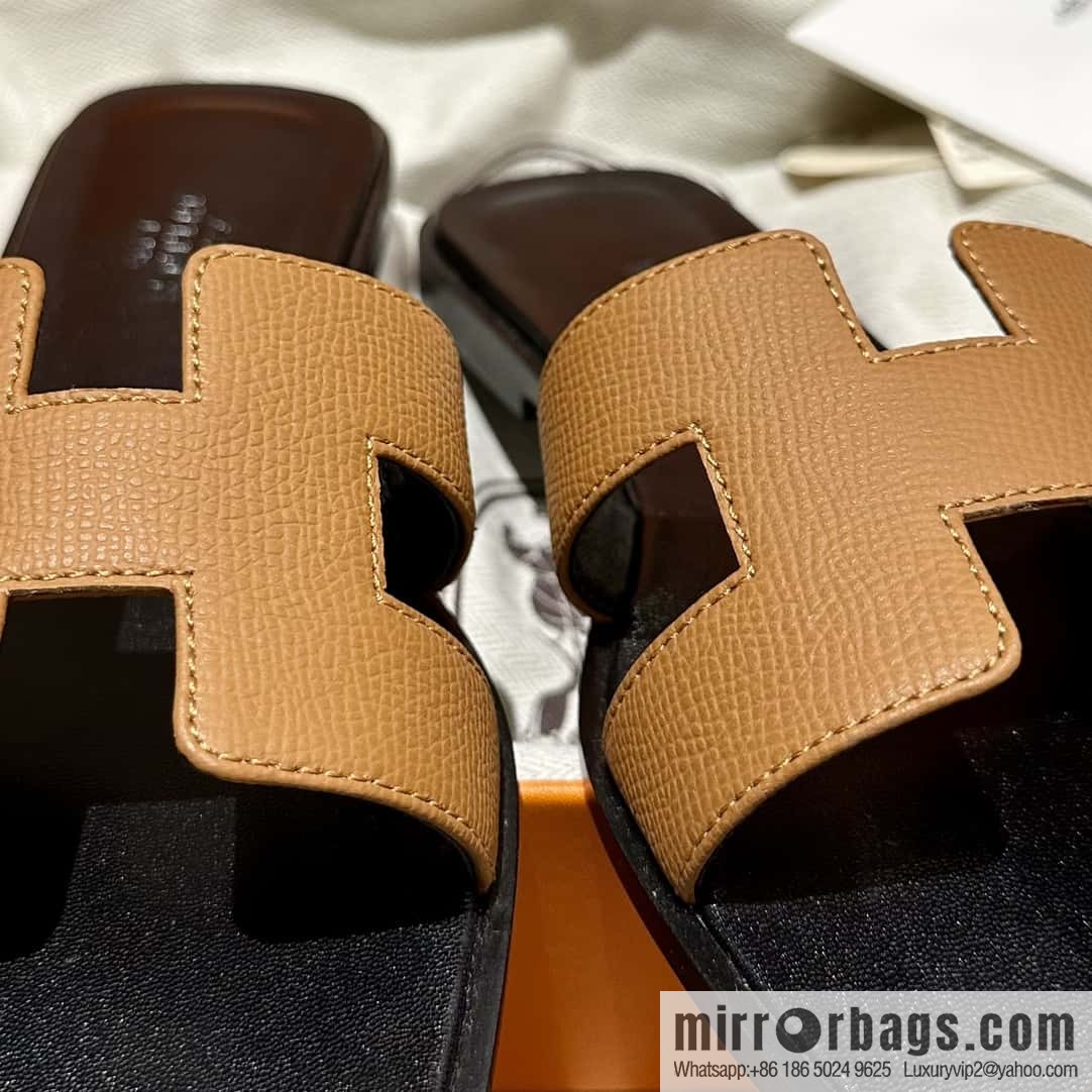 Hermès leather outsole H slippers, black and brown.