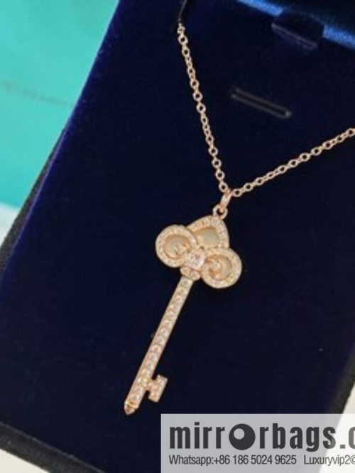 TIFFANY & CO. Tiffany & Co. Fleur de Lis white shell key pendant necklace
