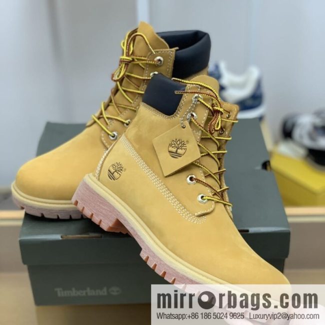 Timberland\'s beige frosted leather with white stitching and side stamping His & Hers boots